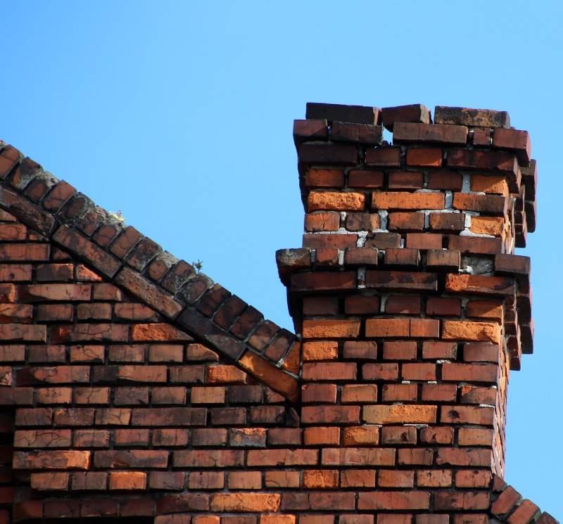 Damaged chimney on an Harvey home showing cracks and missing mortar